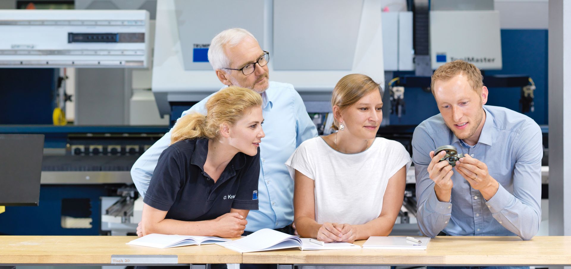 TRUMPF employees talking about a sample part